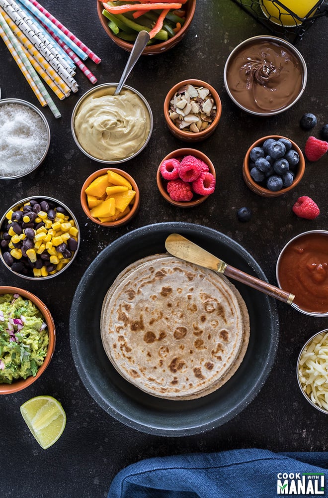 rotimatic roti with different toppings in small bowls for a roti party