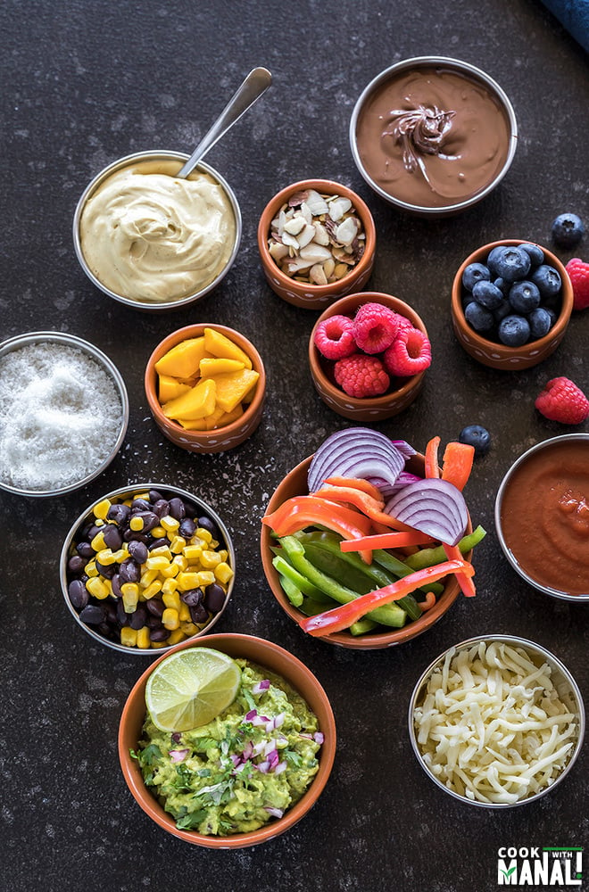 savory and sweet toppings in different bowls for a roti party