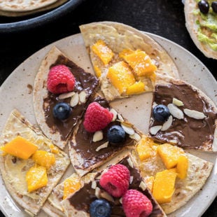 rotis cut into triangles and topped with nutella, mango and berries