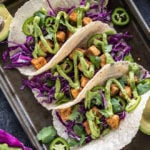 3 crispy tofu tacos topped with avocado lime crema