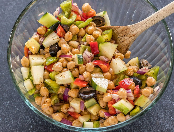 bowl with chickpeas, chopped onion,olives, cucumber and pepper