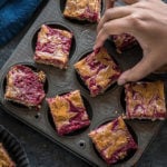 pair of hand holding a vegan peanut butter & jelly bar