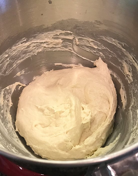 a sticky dough ball in a steel bowl