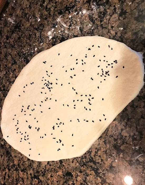 rolled naan topped with nigella seeds