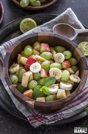 Indian fruit chaat in a wooden bowl