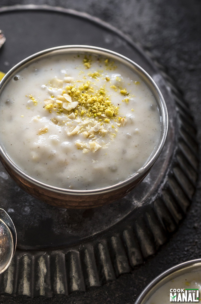 sabudana kheer in a small copper bowl garnished with crushed pistachios