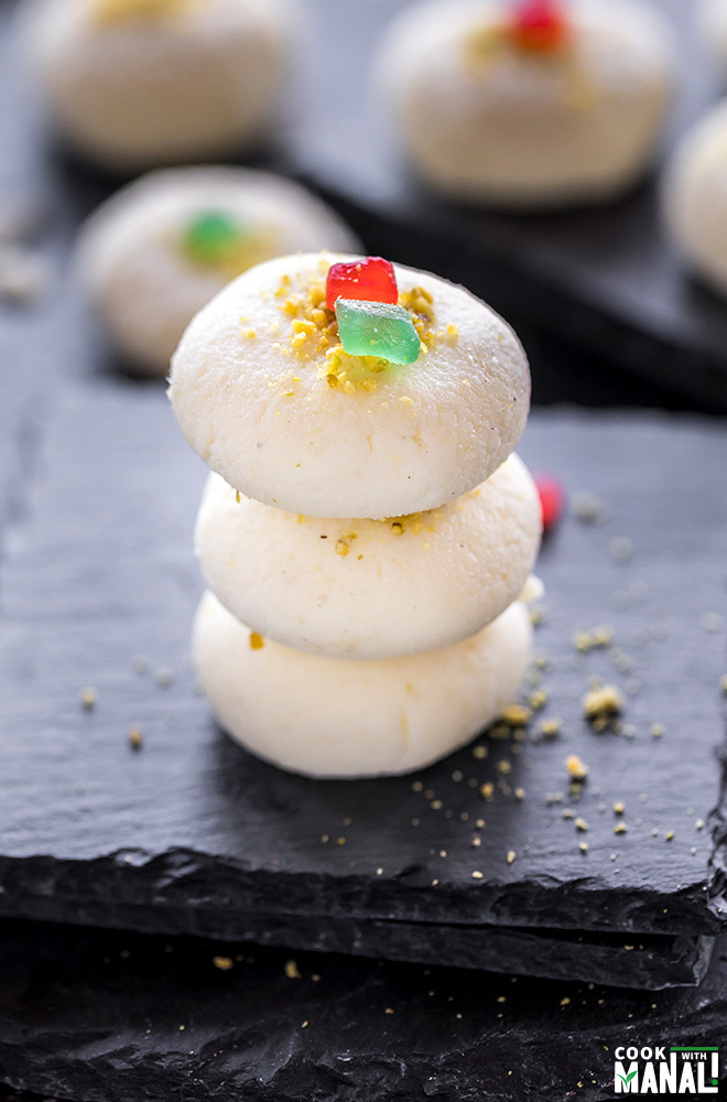 three pieces of sandesh sweet stacked together