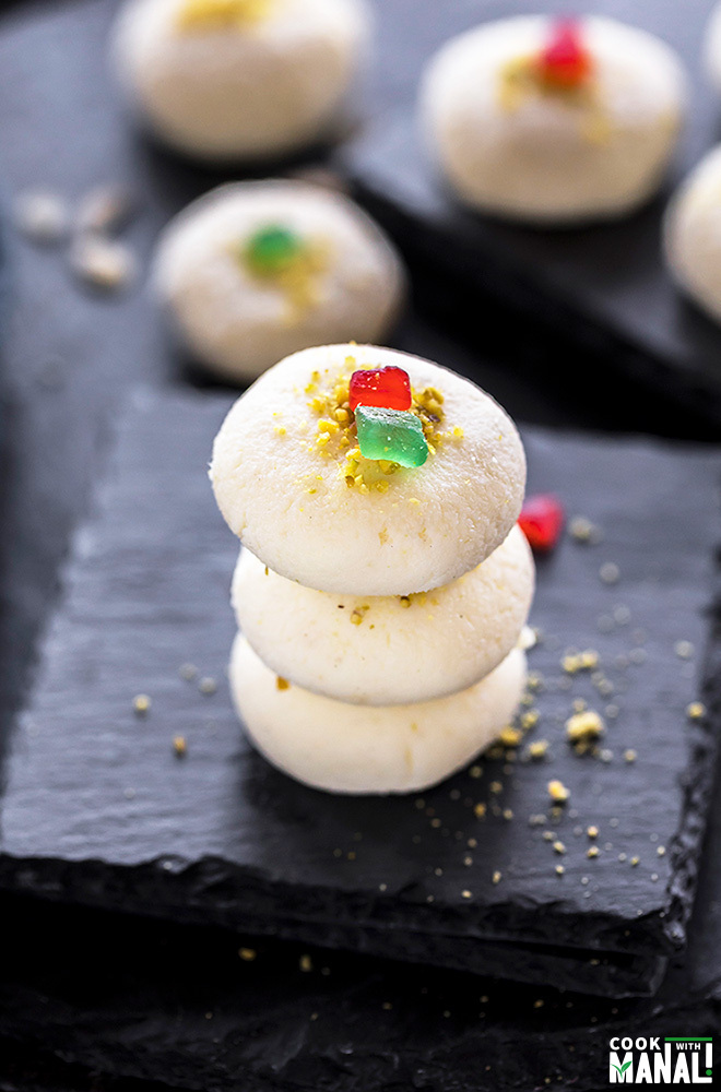 three pieces of sandesh sweet stacked together 
