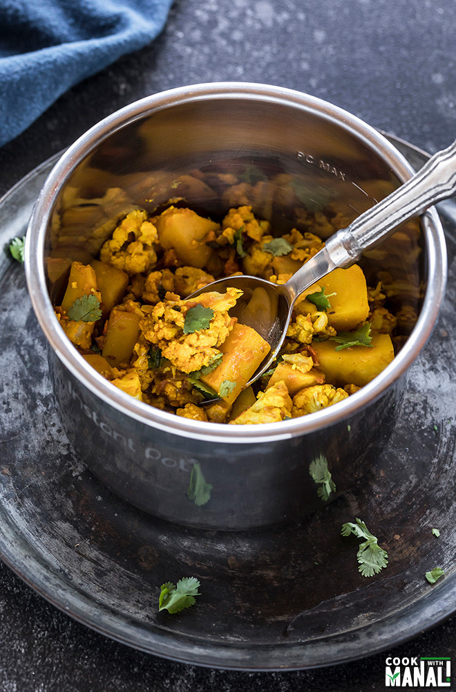 Aloo Gobi in Instant Pot with a spoon