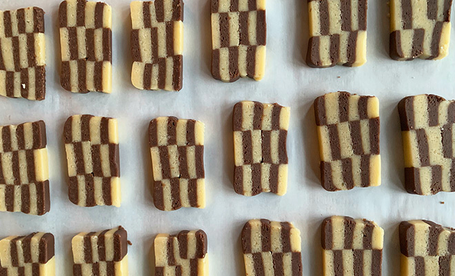 checkerboard cookies arranged on a baking tray