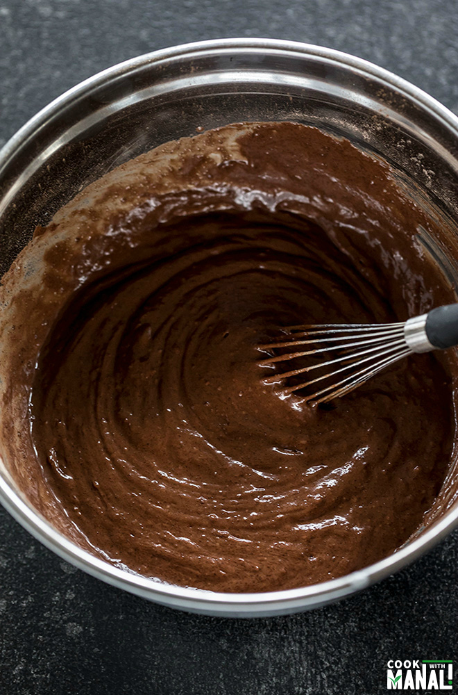 eggless chocolate cake batter being whisked in a bowl