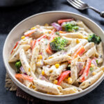 bowl of white sauce pasta with veggies
