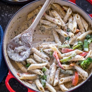 bowl of white sauce pasta with veggies