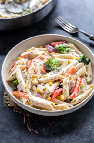 bowl of white sauce pasta with veggies