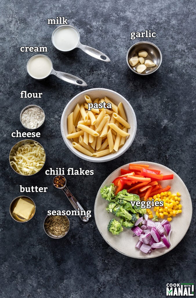 ingredients for white sauce pasta arranged on a board