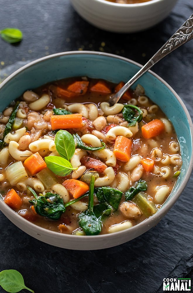bowl of instant pot minestrone soup with a spoon on the side