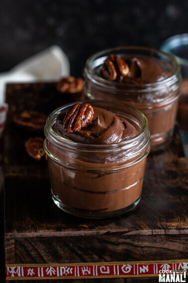 avocado chocolate pudding in a mason jar with more jars in the background