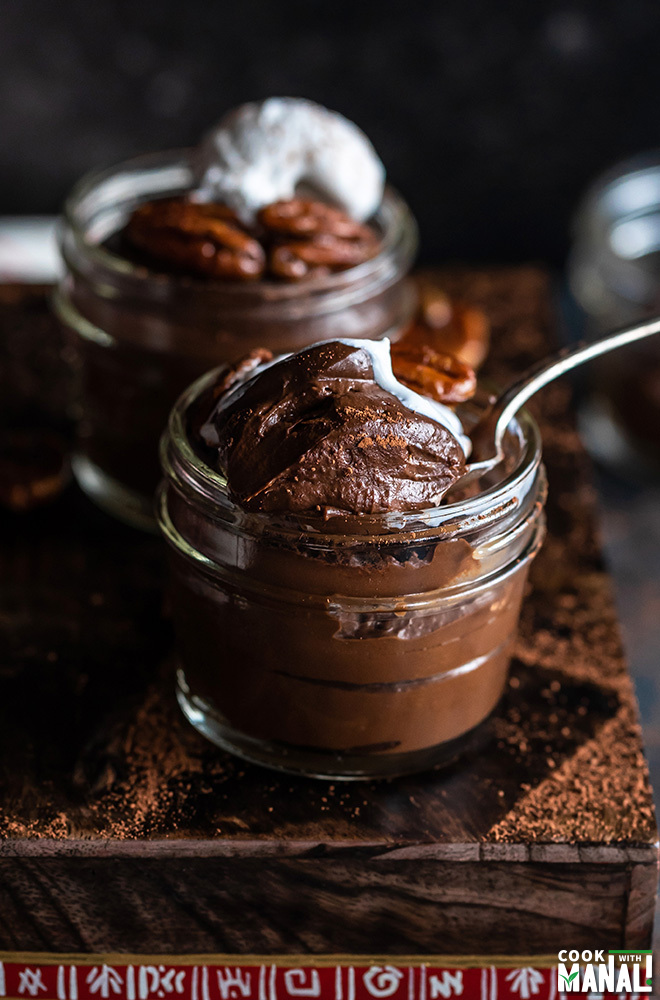 chocolate avocado pudding in a mason jar with a spoon