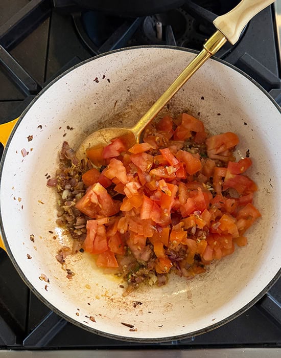 chopped tomatoes with onions in a pot