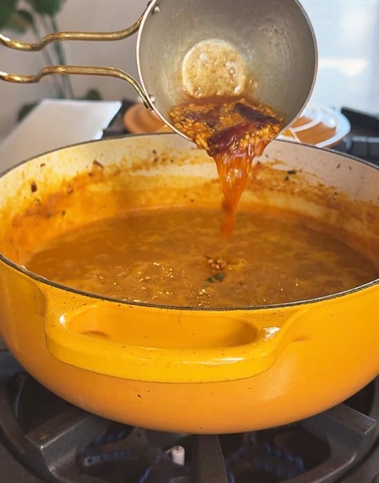 tadka being poured over dal