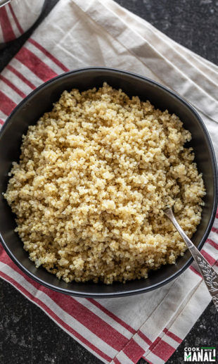 quinoa cooked in instant pot served in a black bowl with a spoon