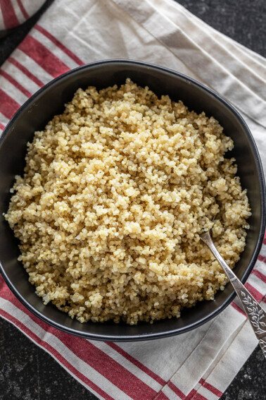 quinoa cooked in instant pot served in a black bowl with a spoon