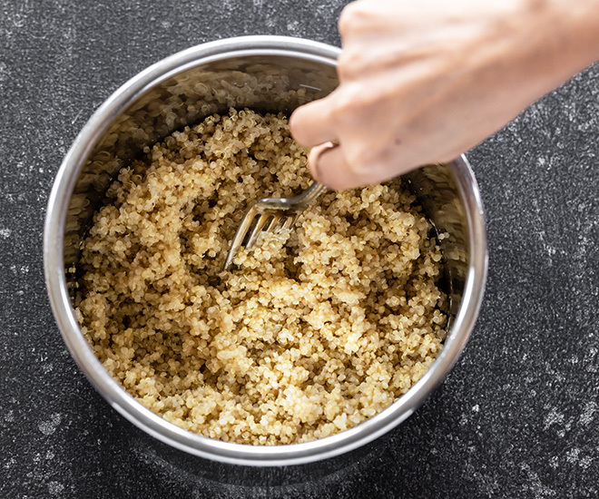 instant pot quinoa being fluffed with a fork