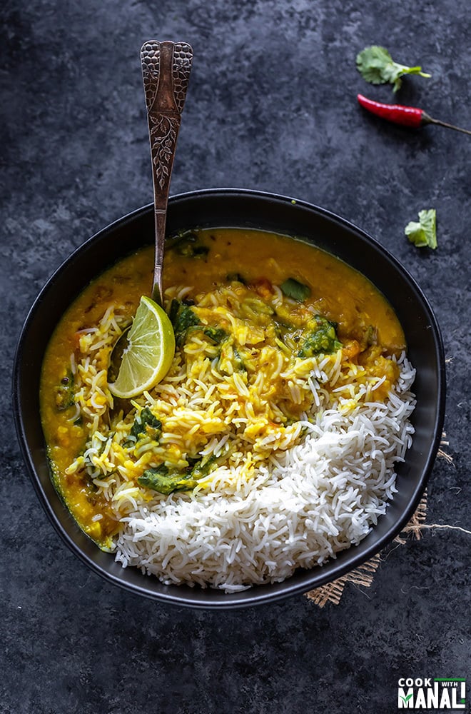 rice and dal in a bowl with a lemon wedge 