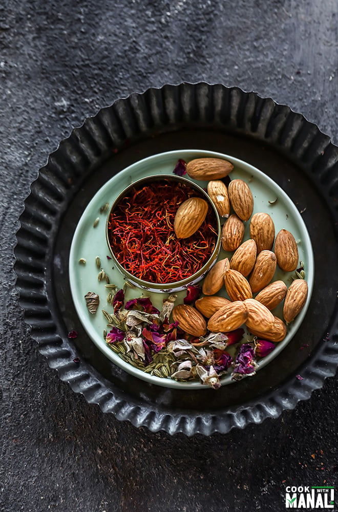 a small plate with almonds, saffron and dried rose petals