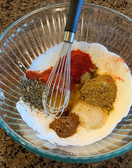 whisked yogurt in a bowl with spices