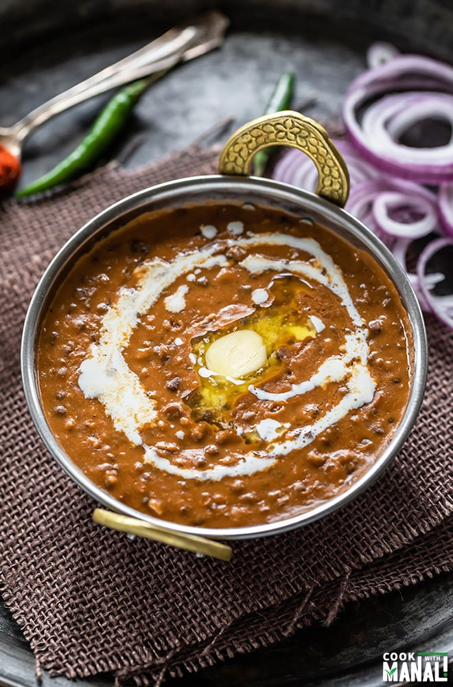 dal makhani served in a copper kadai topped with butter and cream