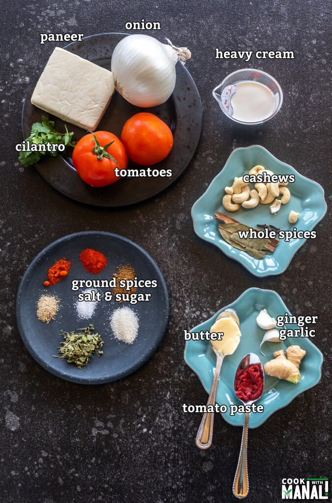 ingredients for making paneer butter masala arranged on a board