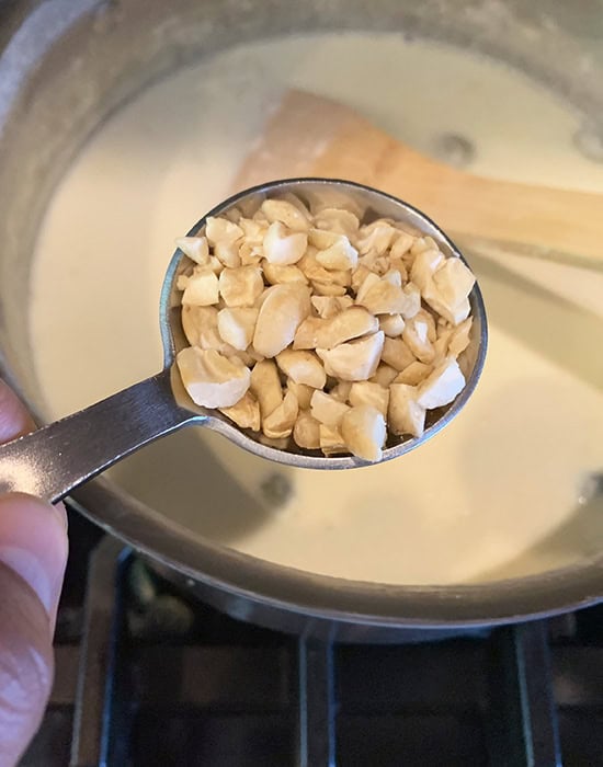 chopped nuts being added to kheer