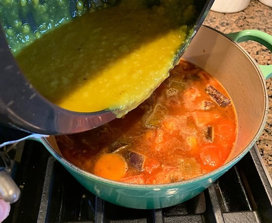 dal being added to a pot from cooker