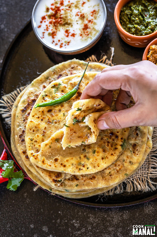 taking a bite from paneer paratha