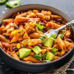 southwestern pasta served in a black bowl with a fork