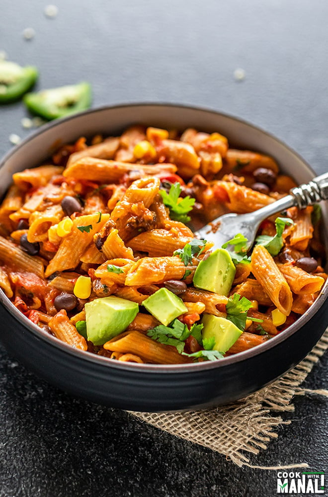 southwestern pasta served in a black bowl with a fork