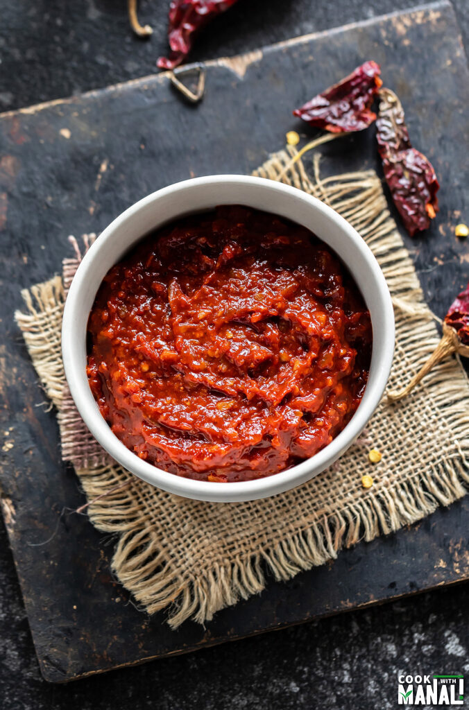 spicy red sauce placed in a white bowl