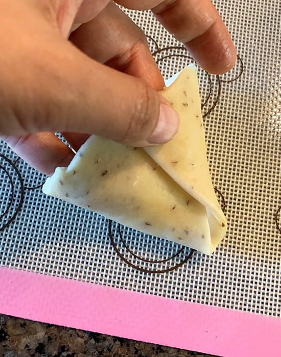 pinching the edges of the dough to bring it together