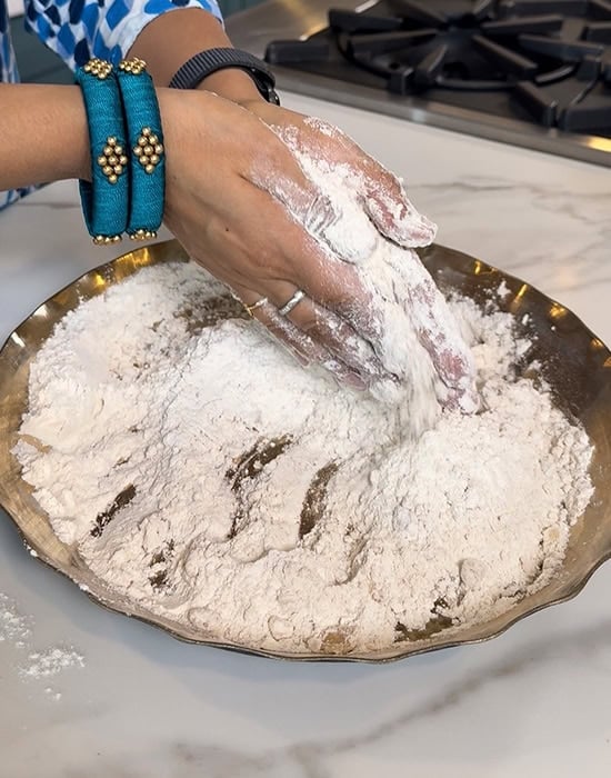 rubbing oil into the flour using hands