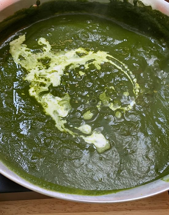 spinach puree with heavy cream in a steel pan