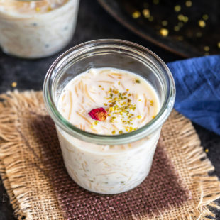 instant pot seviyan kheer served in a glass jar and garnished with rose petals and pistachios