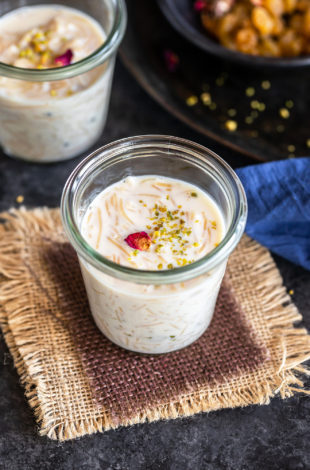 instant pot seviyan kheer served in a glass jar and garnished with rose petals and pistachios
