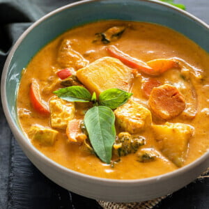 vegan panang curry served in a bowl and garnished with basil