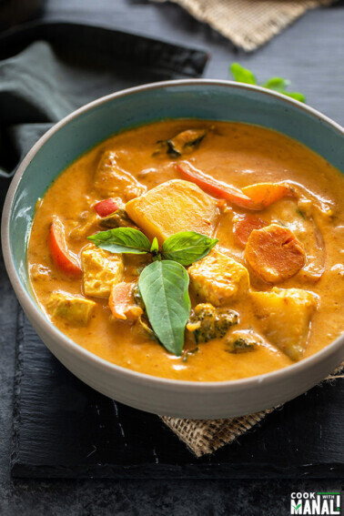 vegan panang curry served in a bowl and garnished with basil