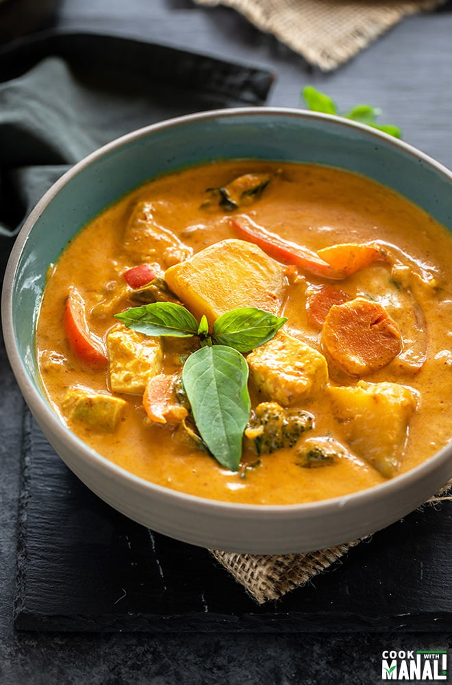 vegan panang curry served in a bowl and garnished with basil