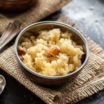 sooji halwa served in a small copper bowl with one more bowl in the background