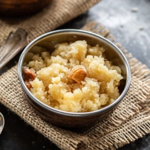 sooji halwa served in a small copper bowl with one more bowl in the background
