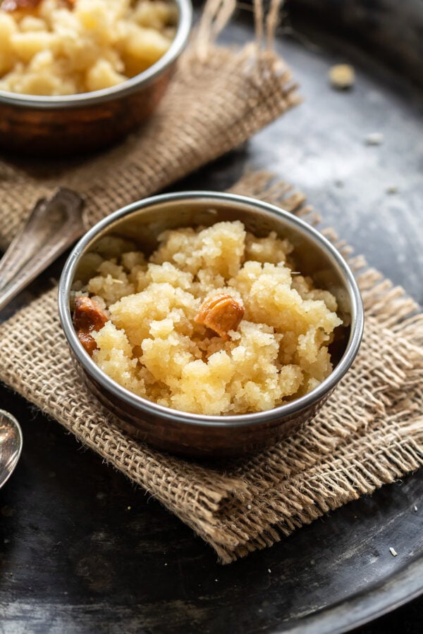 sooji halwa served in a small copper bowl with one more bowl in the background