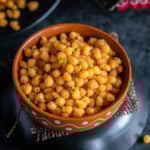 bowl of sweet boondi with a diya in the background